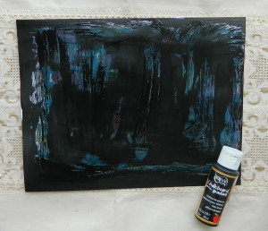 Step three art journal tutorial covering paint with petroleum with black paint