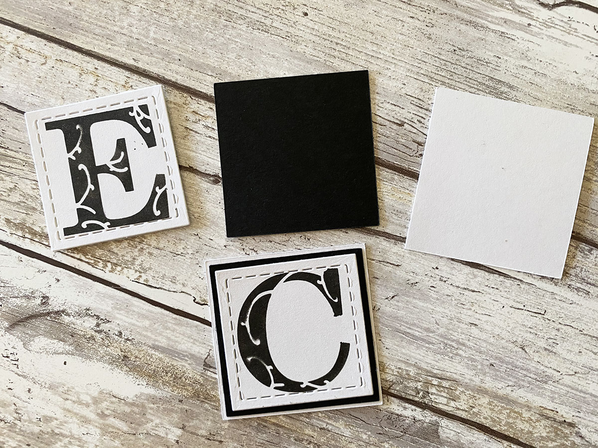 Attach stenciled letters onto black and white cardstock.