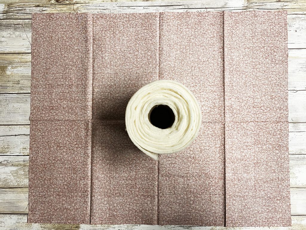 Place batting roll onto the center of the fabric