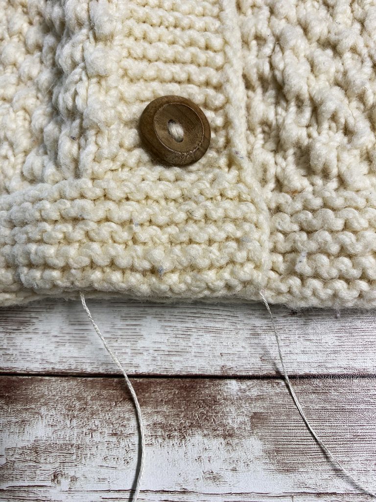 Sew the bottom edge of the sweater to make a pillow