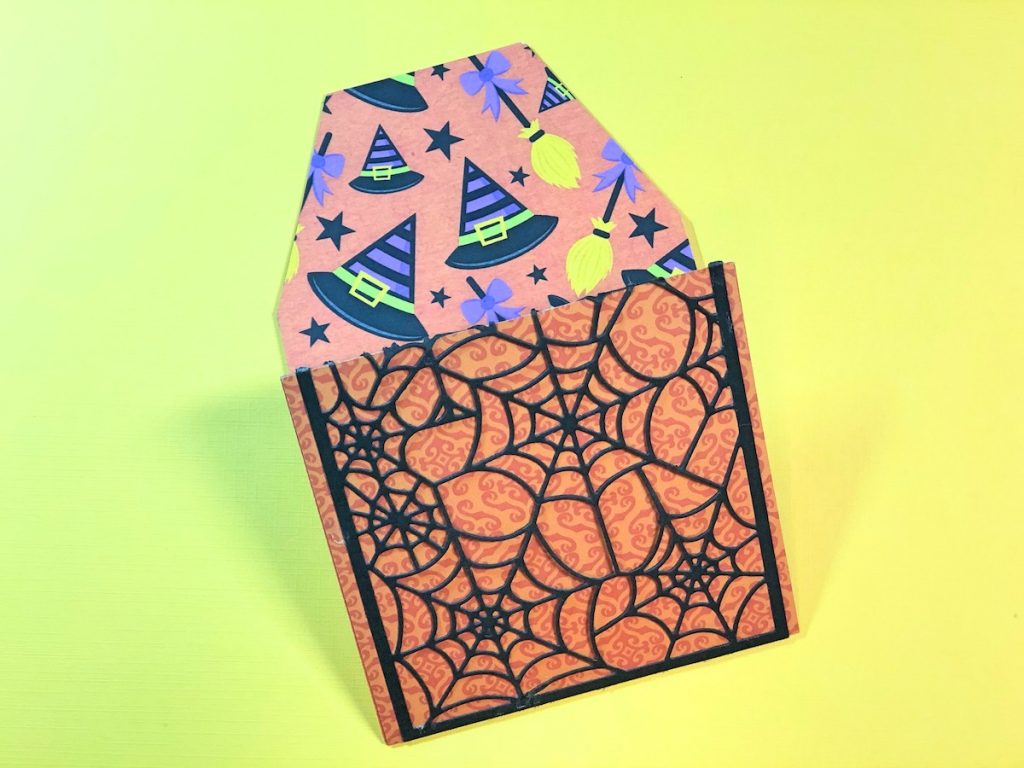 Adhere Patterned Papers & Spider Web to Tag